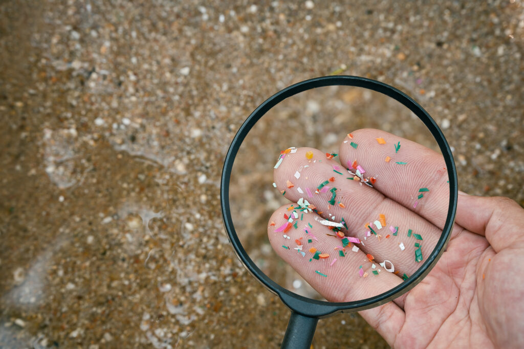 Close up side shot of microplastics laying on a hand.